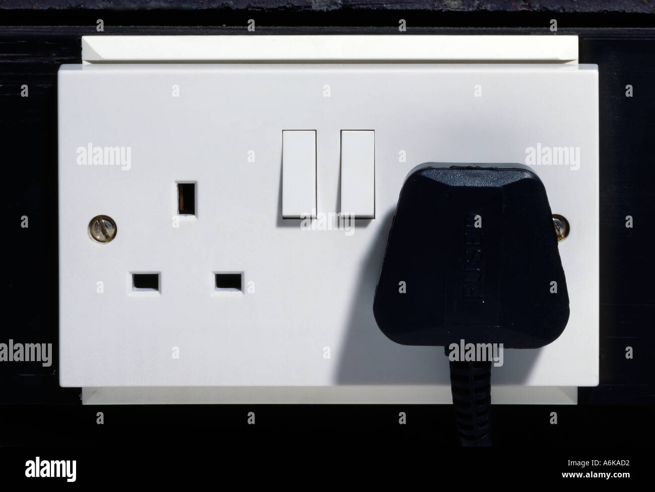 British electrical plug in wall socket Stock Photo Alamy