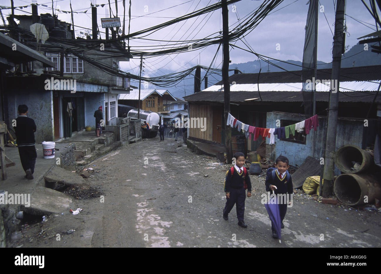 Two schoolchildren go to school in the town of Lava, Darjeeling District, India Stock Photo