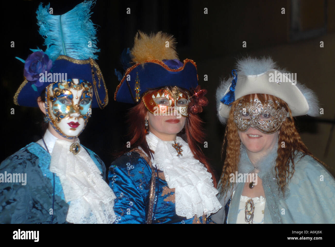 Three ladies on a bridge in Carnival masks during Carnival Venice 2007 Stock Photo