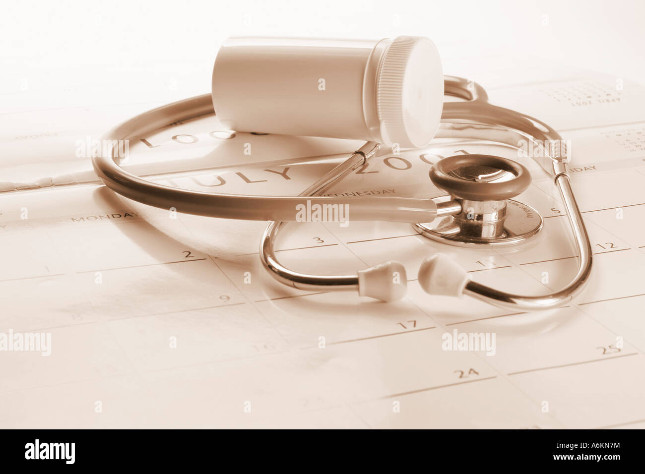 Stethoscope and Pill Holder on Calendar Stock Photo