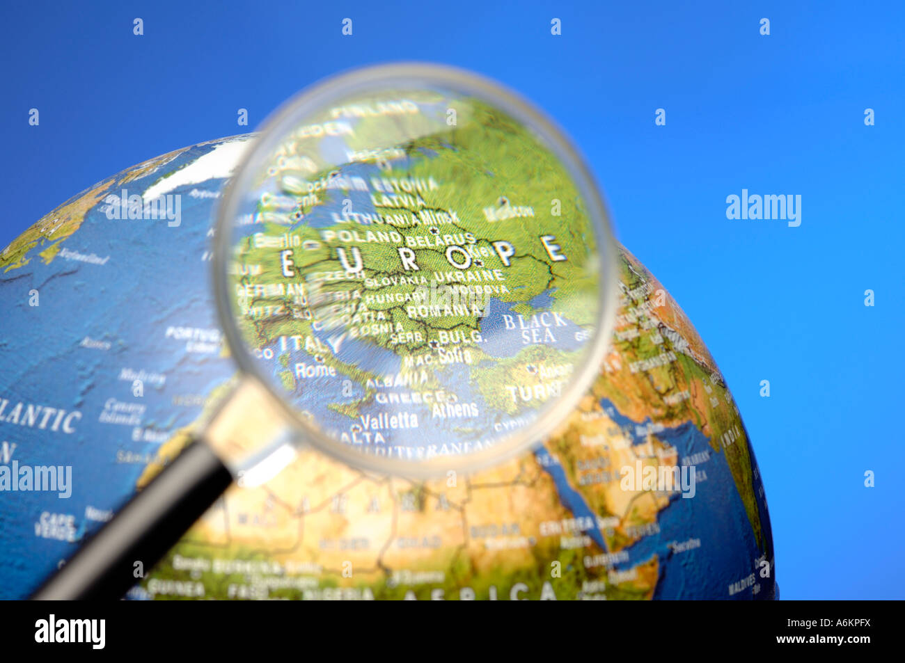 Magnifying glass and  globe focussed on Europe Stock Photo