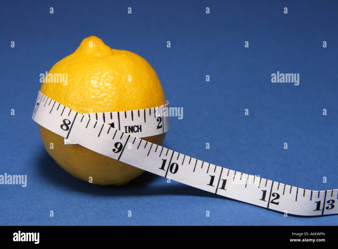 Measuring tape wrapped around a lemon. Concept of diet. Stock Photo