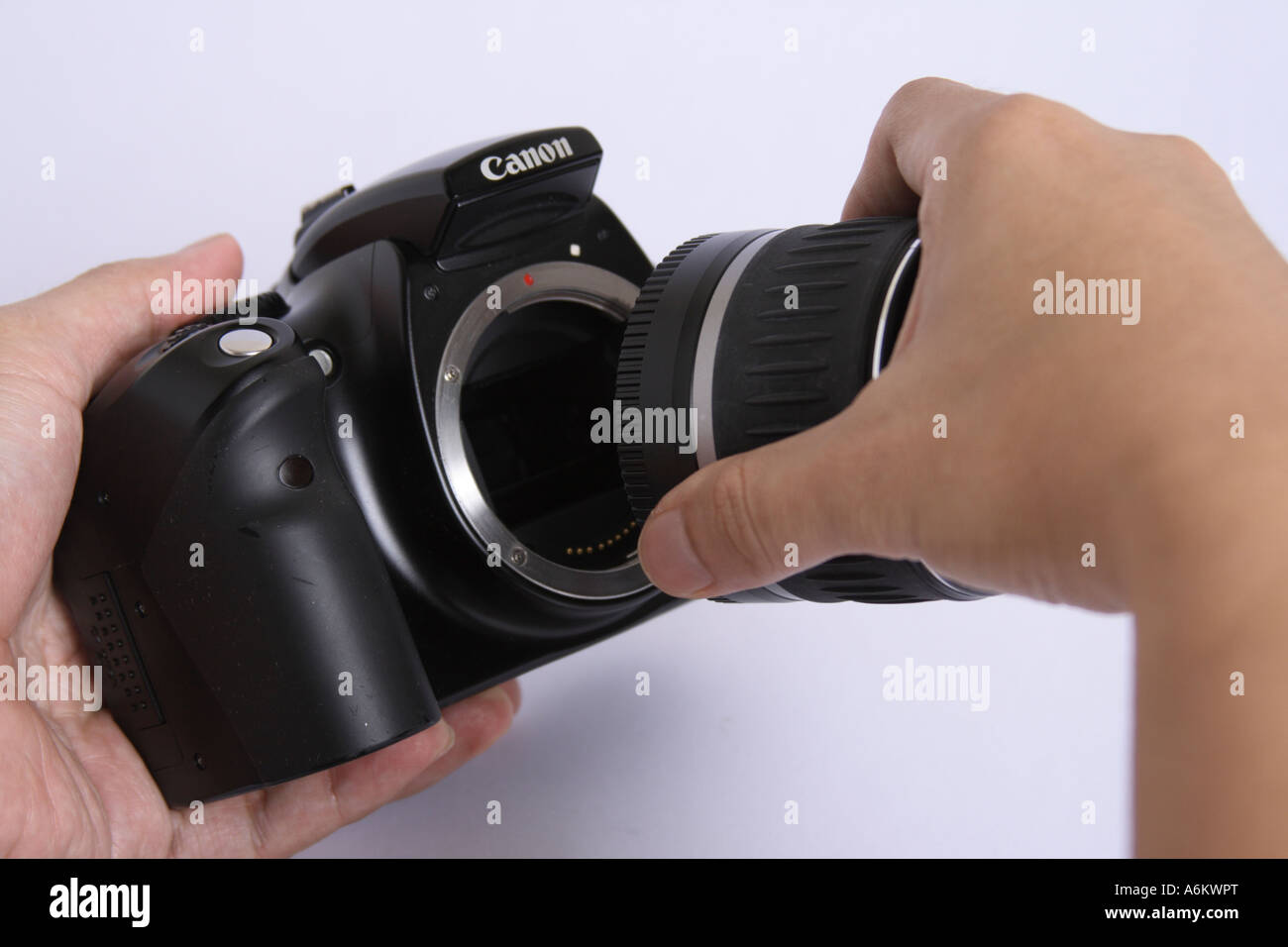 hand attaching lens to a DSLR camera Stock Photo Alamy