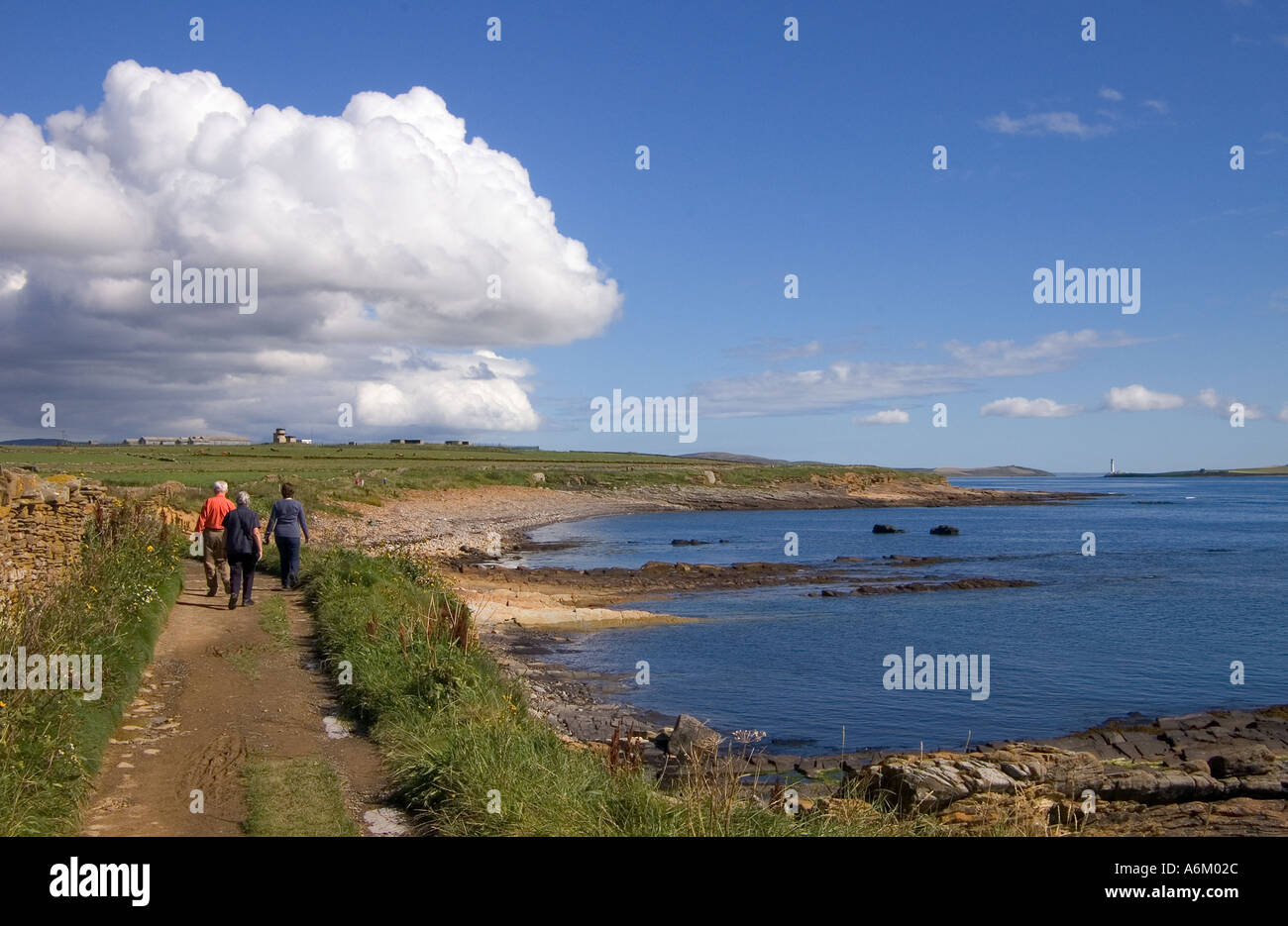 dh Scapa Flow scotland HOY SOUND ORKNEY ISLES People on coastal path family walk coast sea uk holiday summer walking Stock Photo