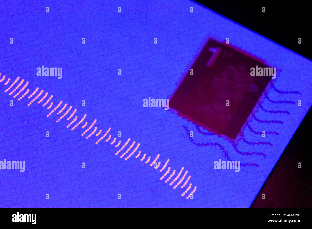a letter illuminated with ultraviolet light showing the fluorescent ...