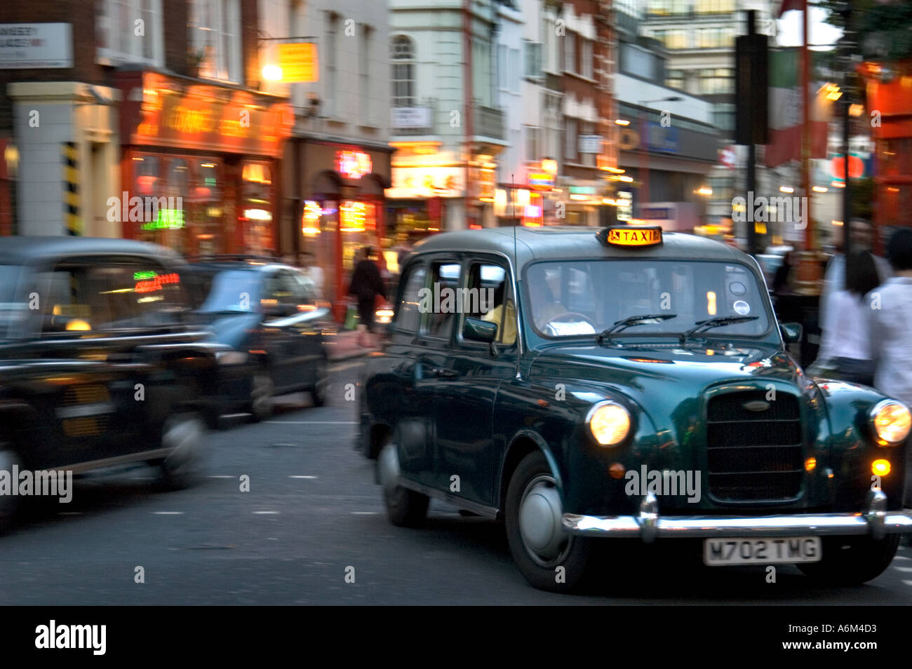 Black taxicabs Chinatown Soho Central London Stock Photo