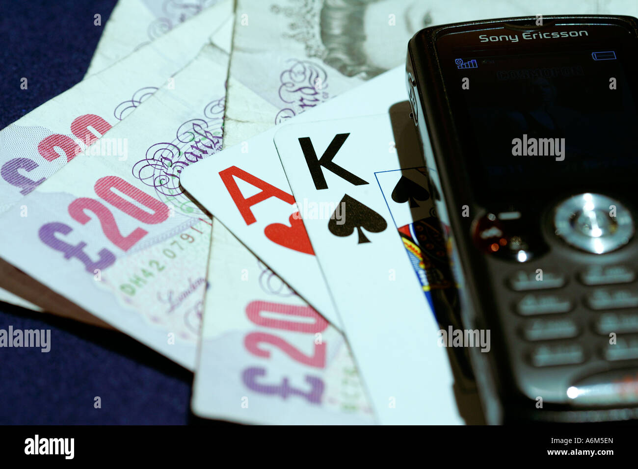 Close up of a casino playing cards pound money ace mobile telephone Stock Photo