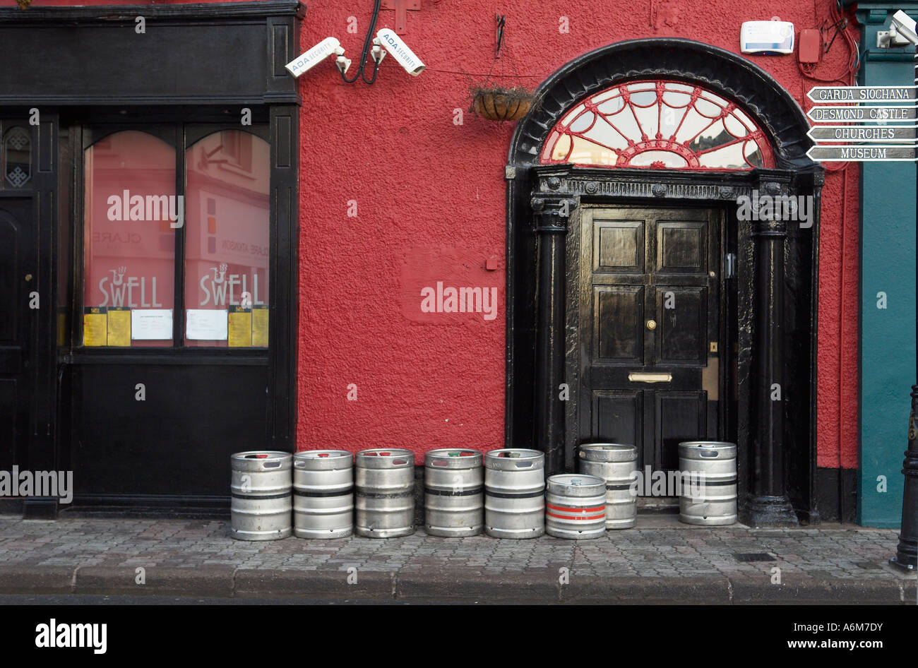 Early morning kegs of beer line the sidewalk outside a pub in Kinsale
