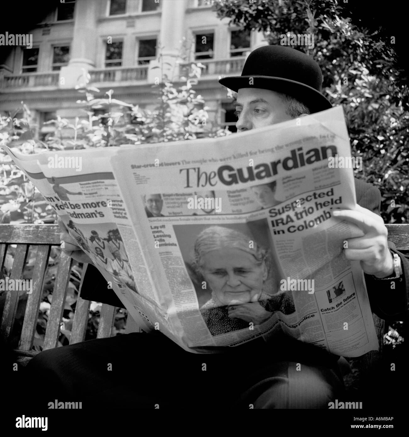 Traditional english businessman reading The Guardian Newspaper Stock Photo