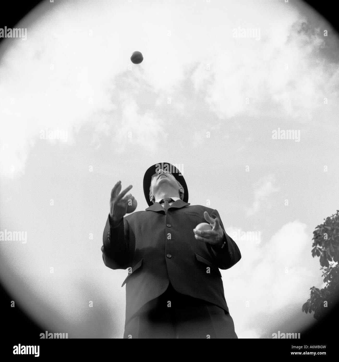 Man in bowler hat juggling Stock Photo Alamy