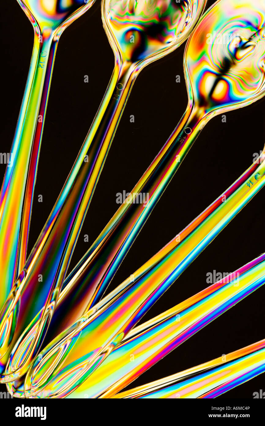 Cross Polarised abstract image of plastic spoons taken with a macro lens close-up showing stress patterns Stock Photo