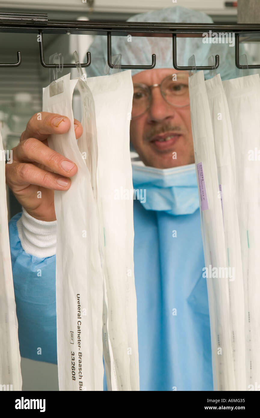 Male nurse reaches for sterile supplies in operating room Stock Photo