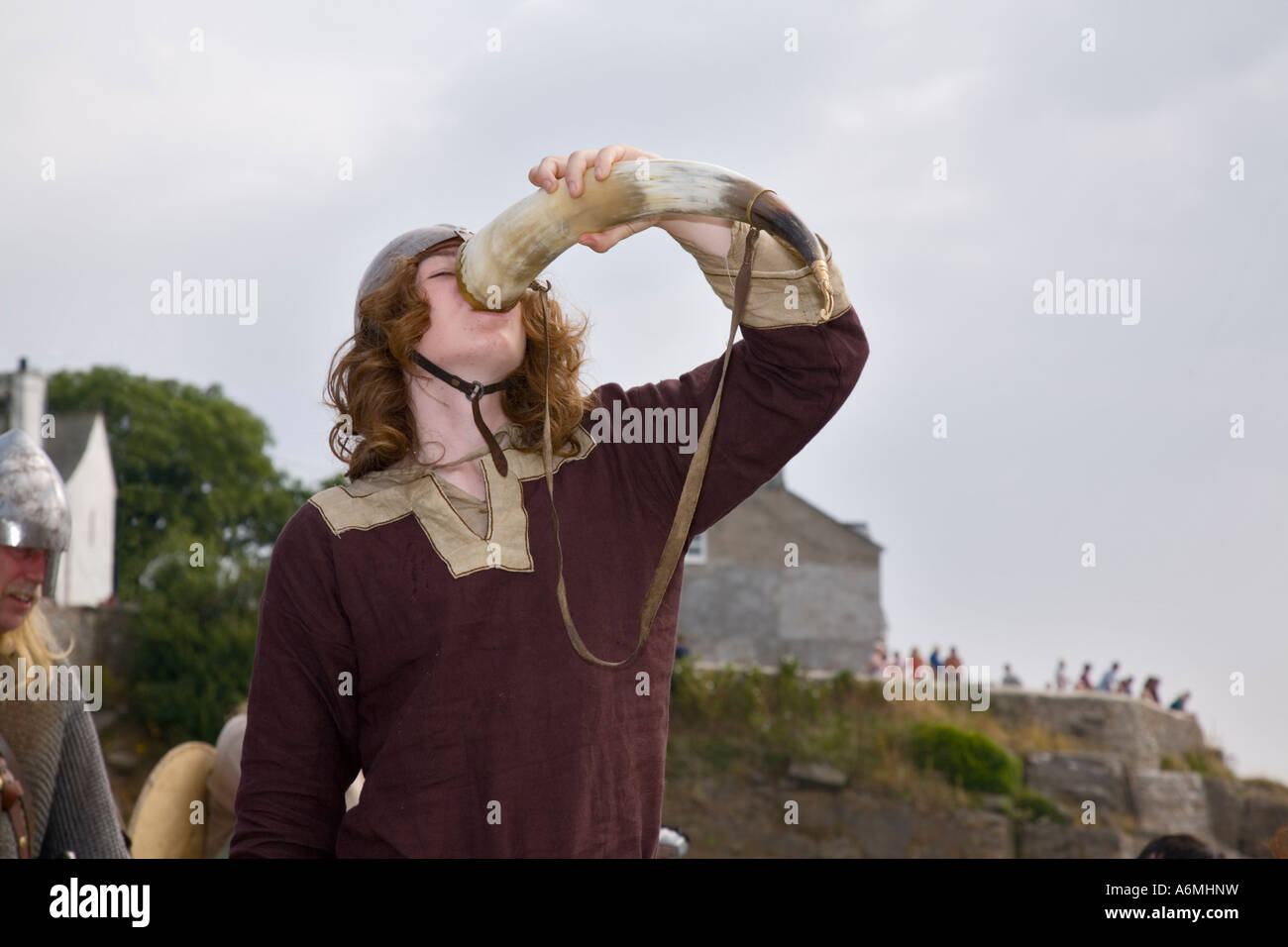 AMLWCH BIENNIAL VIKING FESTIVAL actor with helmet uniform drinking from horn after re-enactment of battle Anglesey Wales UK Stock Photo