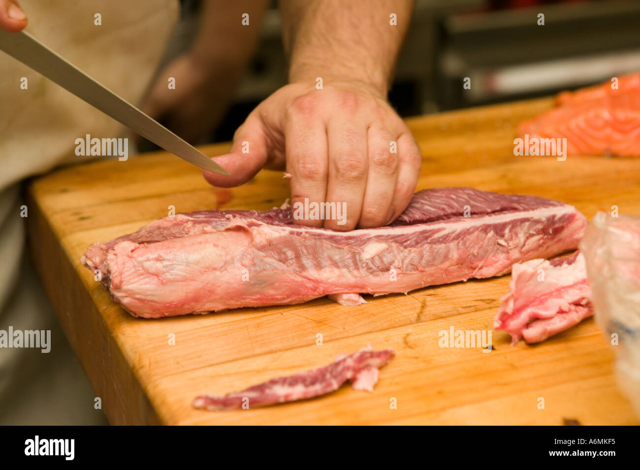 Chef trimming hanger steak called onglet by the French in the kitchen of a fine restaurant upstate New York Stock Photo