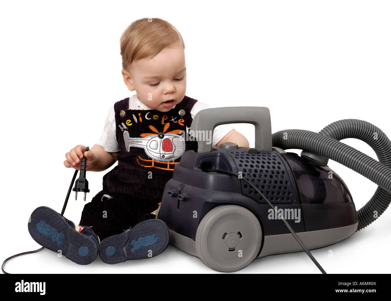 Cute baby boy playing with a vacuum cleaner Stock Photo - Alamy
