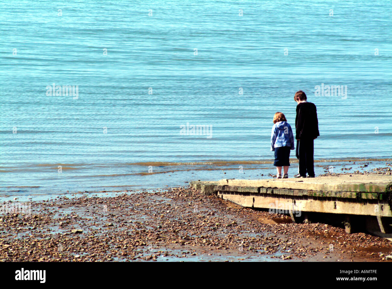 Children relaxing by the sea hi-res stock photography and images - Alamy