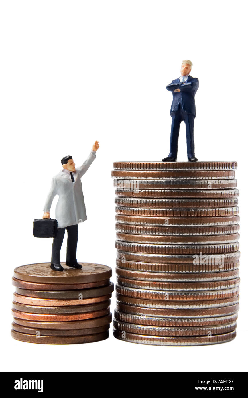 Business figures on stack of quarters Stock Photo Alamy