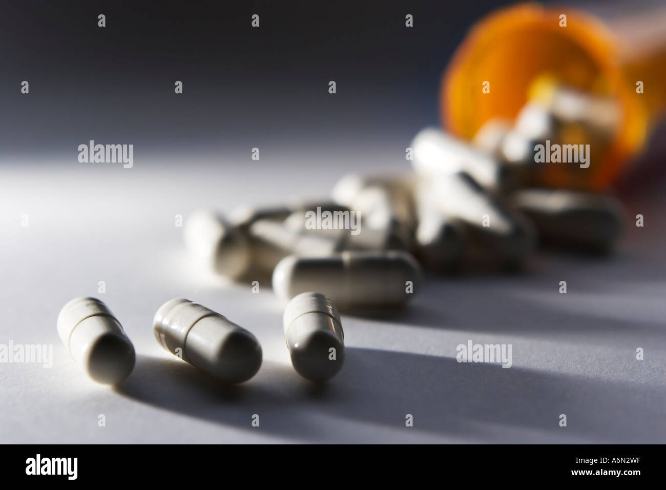 Pills spilling out of a tipped over pill bottle Stock Photo - Alamy