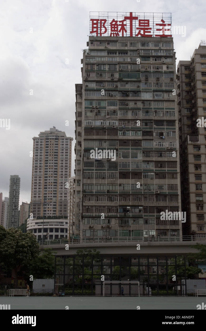 Neglected apartment block overlooking a city centre football pitch in Causeway Bay Stock Photo