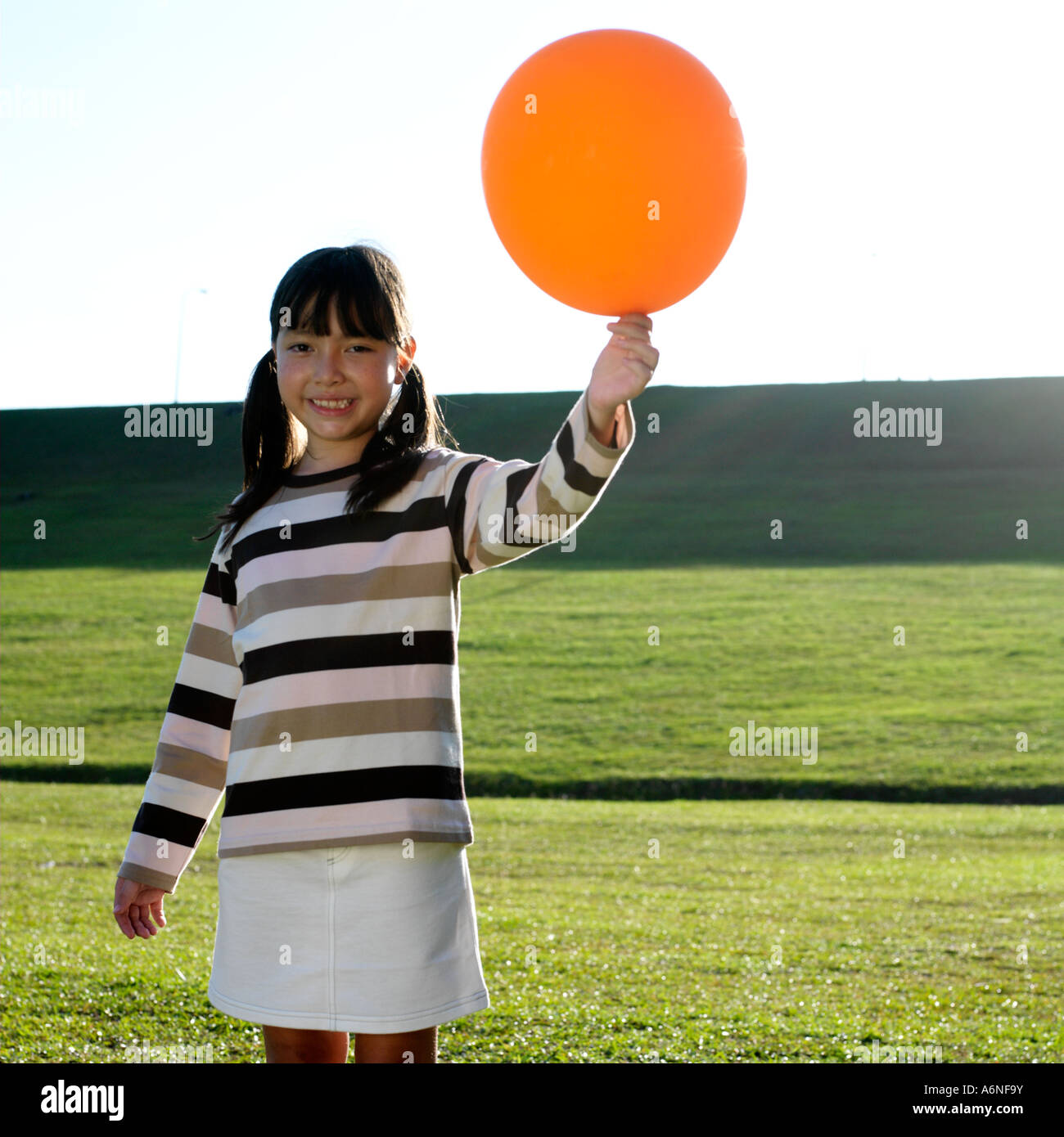 Girl 8 9 holding balloon hi-res stock photography and images - Alamy