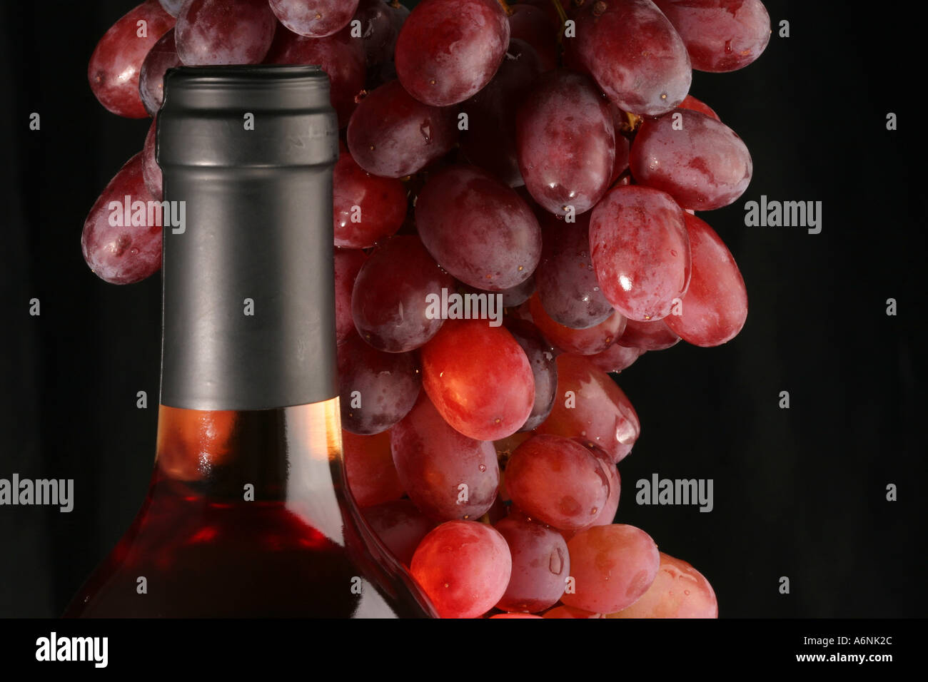 Bottle of red Wine and Grapes Stock Photo