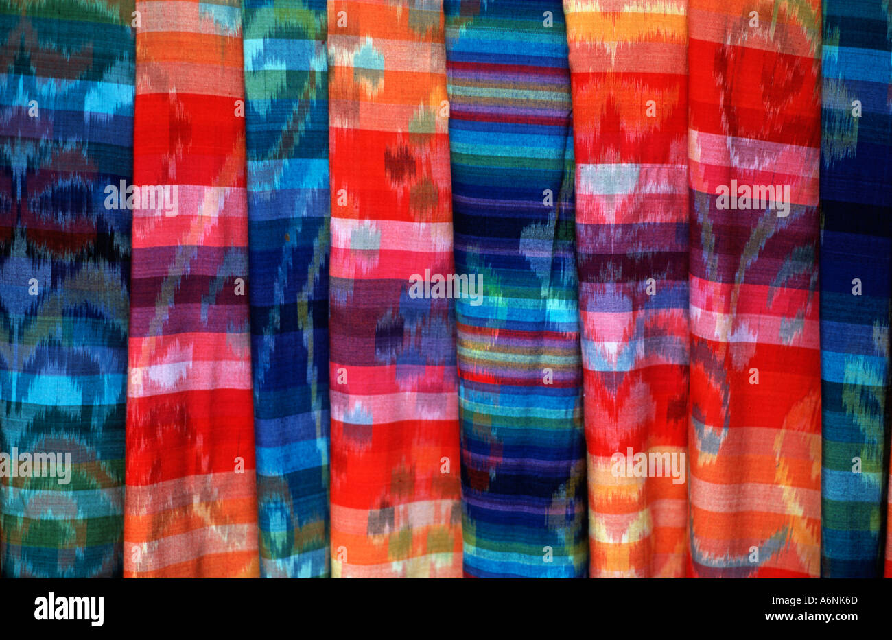 Colourful Balinese woven fabrics for sale on a street stall Ubud Bali Simulated ikat weaving Indonesia Stock Photo