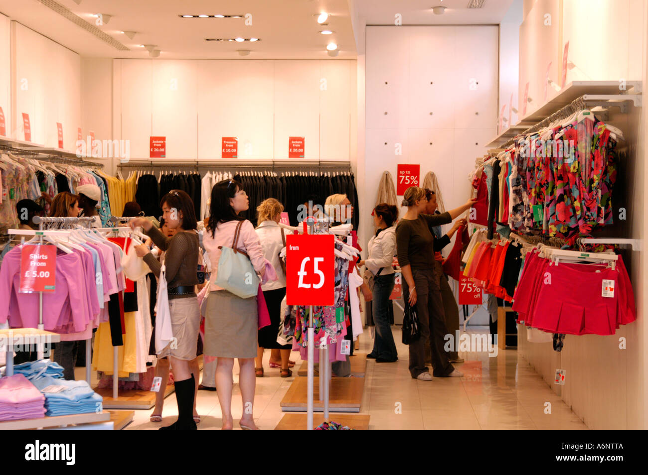 Women shopping at Benetton shop, London, England UK Stock Photo - Alamy