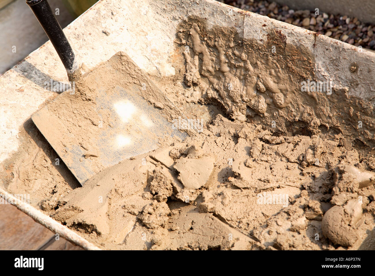 Builders wheelbarrow with fresh mix of cement or mortar and shovel