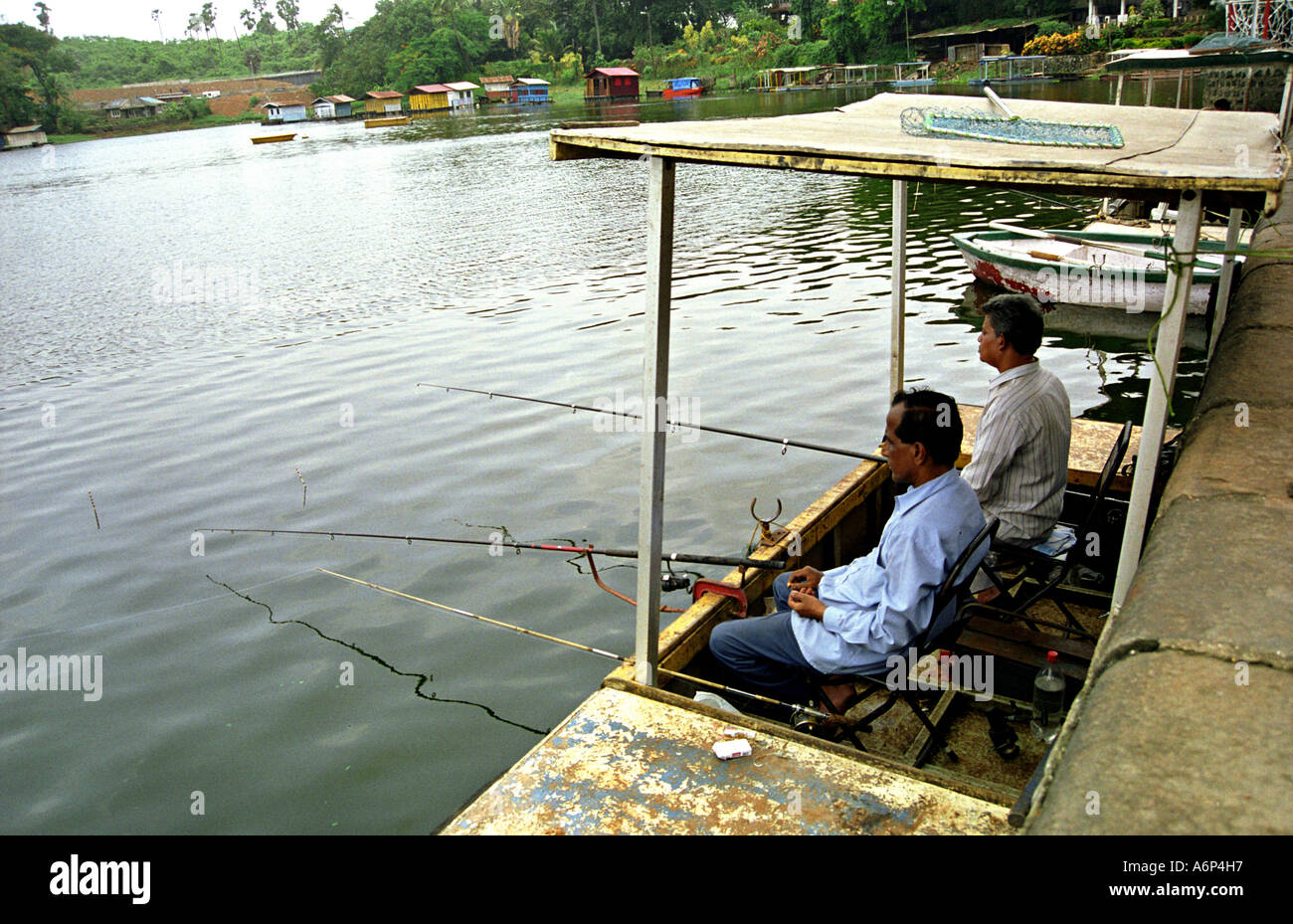 two men fishing at Powai Lake Bombay now Mumbai Maharashtra India Stock Photo