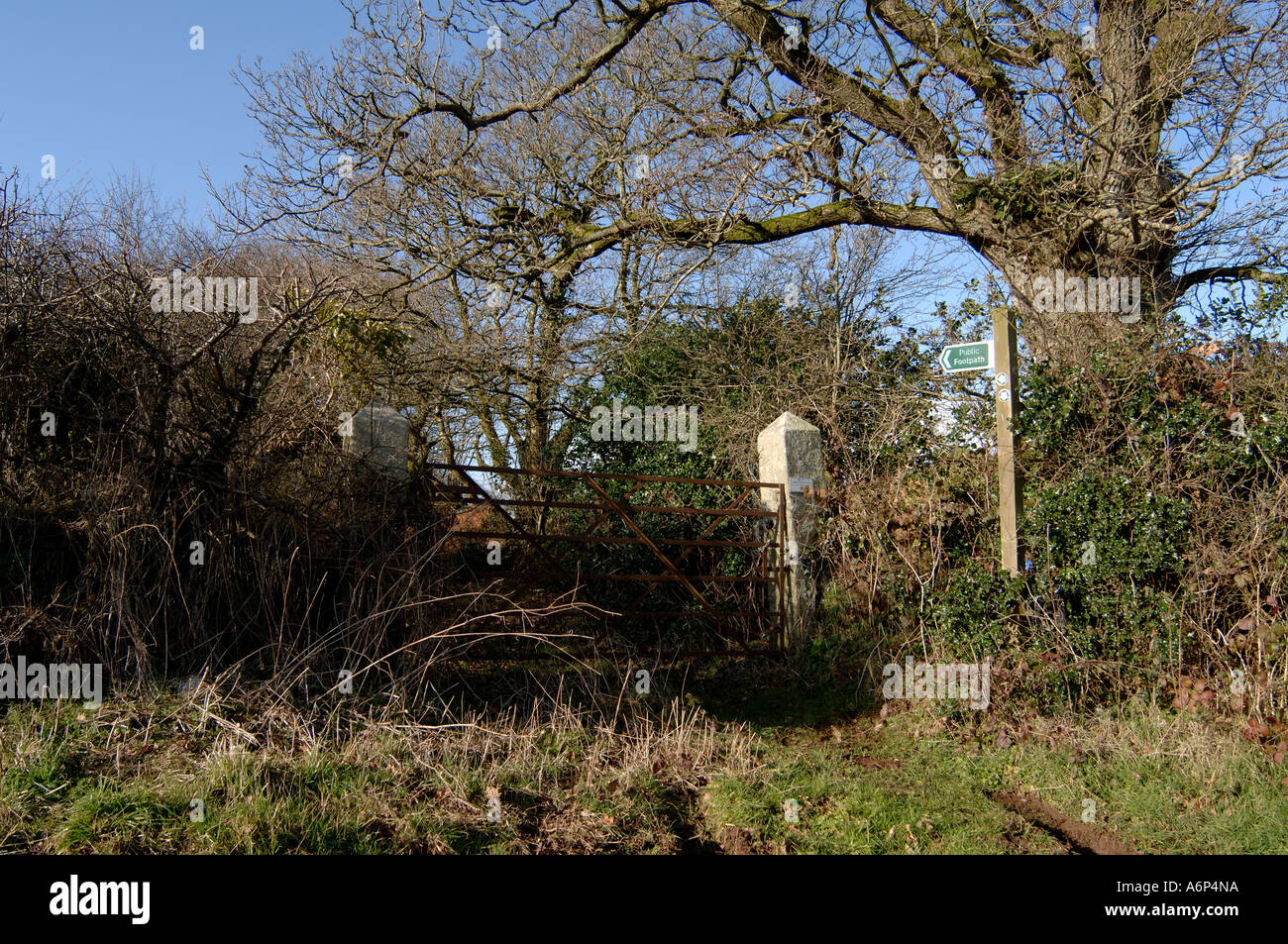 Footpath with metal gate sign and leafless trees in mid Devon in winter Stock Photo