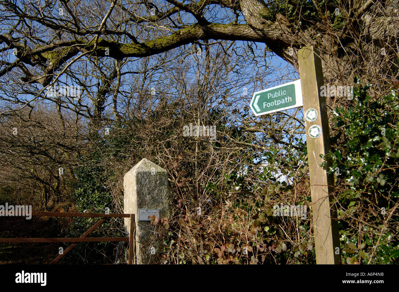 Footpath with metal gate sign and leafless trees in mid Devon in winter Stock Photo