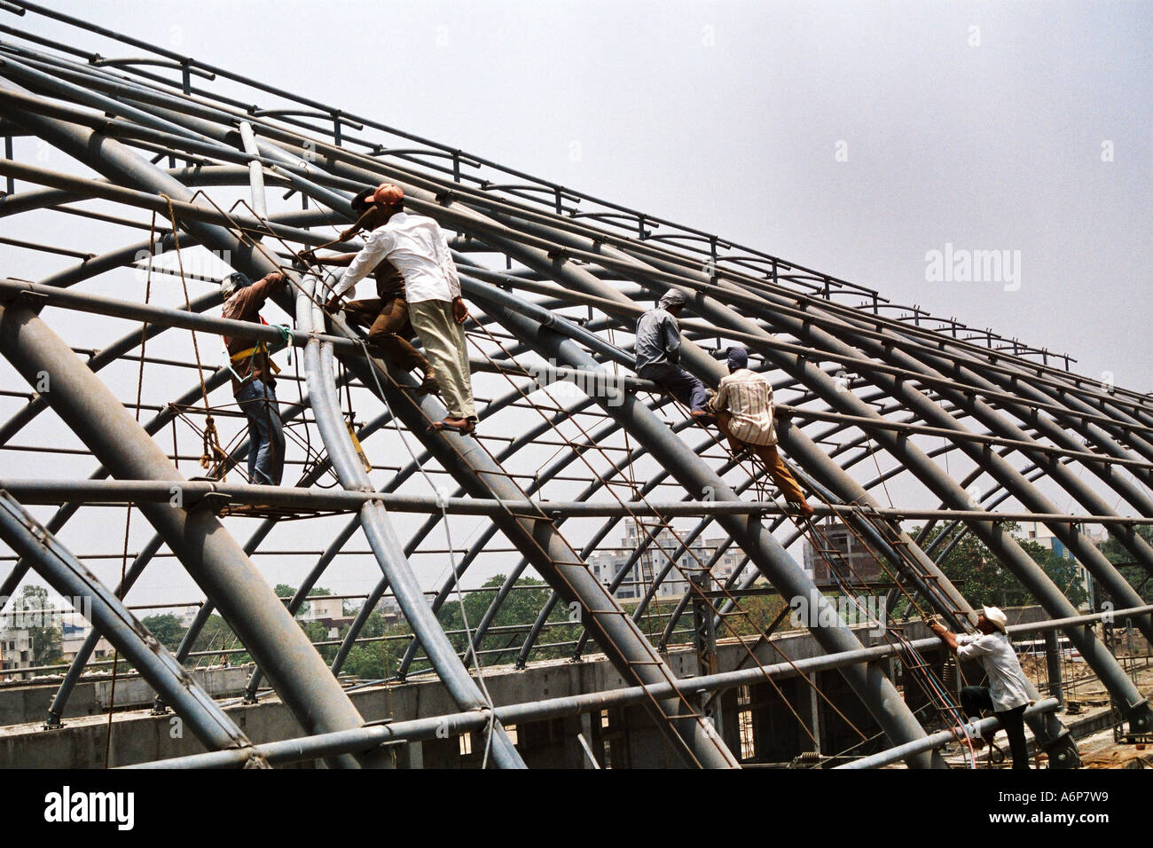 Indian construction workers building ceiling of Kharghar Railway station, Navi Mumbai, India