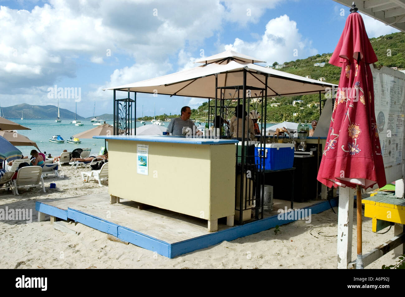 Customers cool off with a chilled drink around a beach bar situated at Frenchman's Cay Resort, Tortola Stock Photo