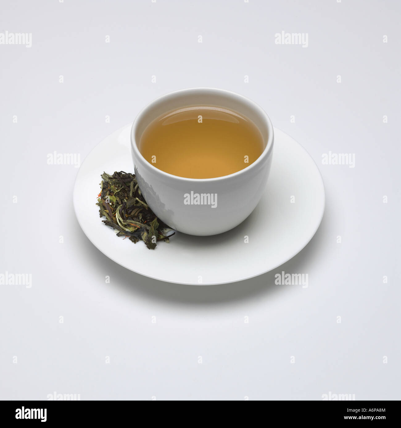 A cup of white ambrosia tea with raw leaves in saucer Stock Photo Alamy