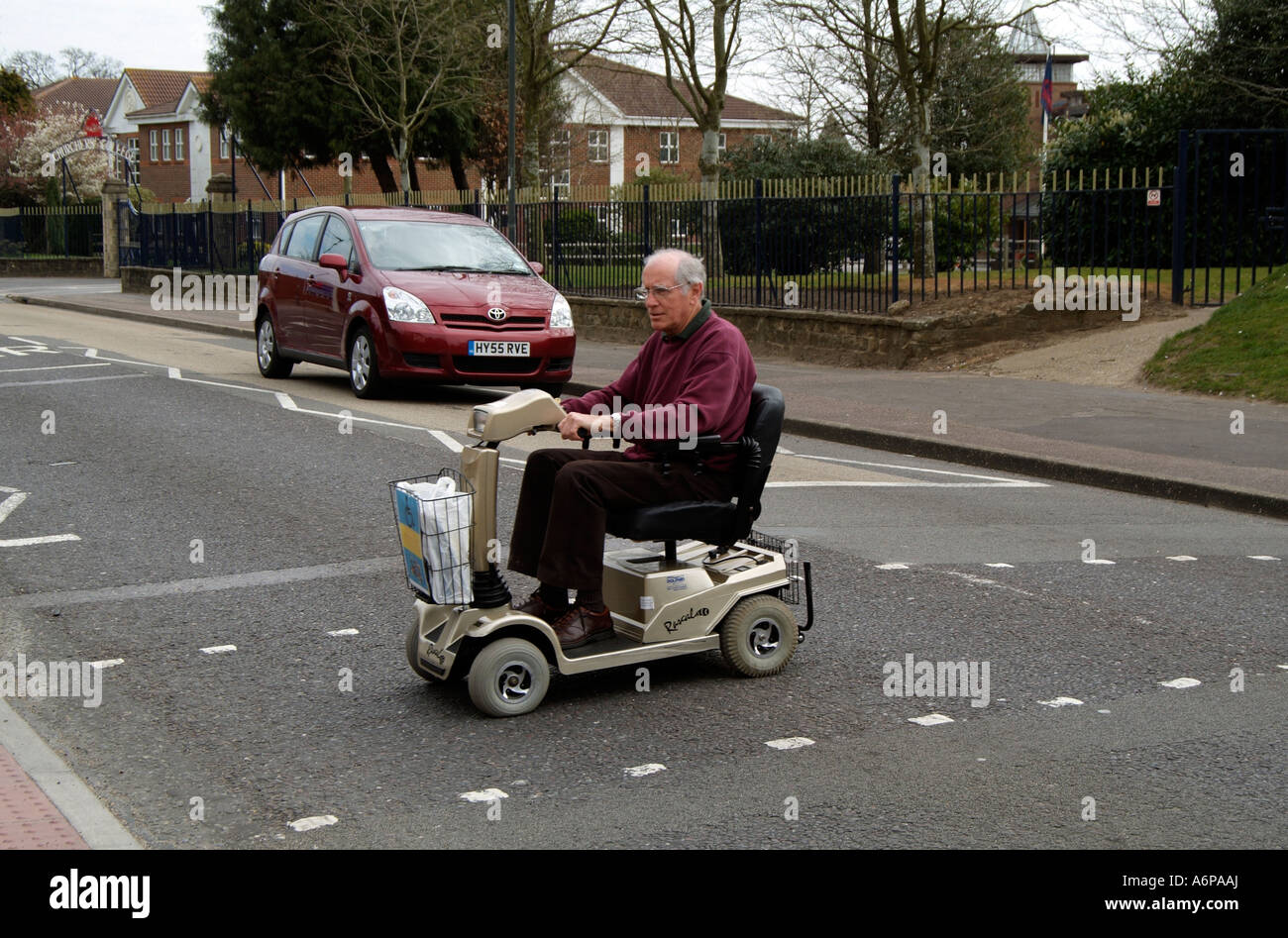 Electric powered mobility scooter Driving across the road at a