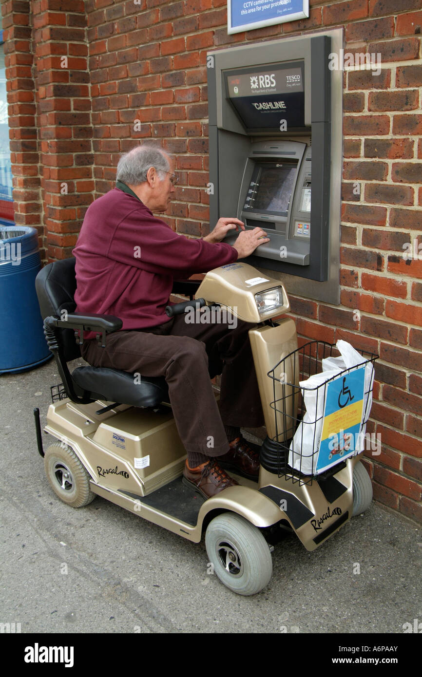 Electric powered mobility scooter Disabled driver using a cash point