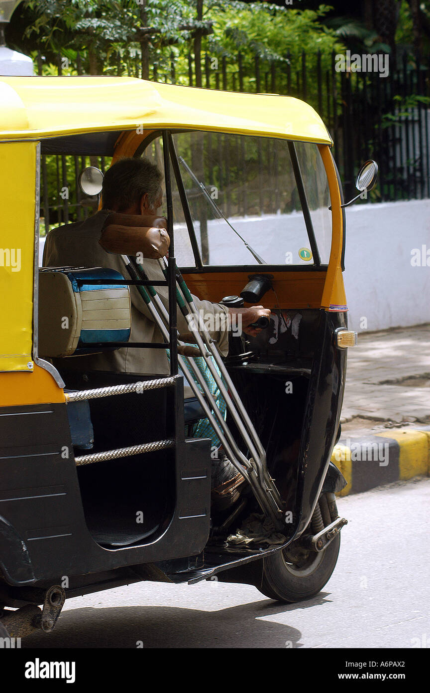 physically handicapped man driving a auto rickshaw in Bangalore city