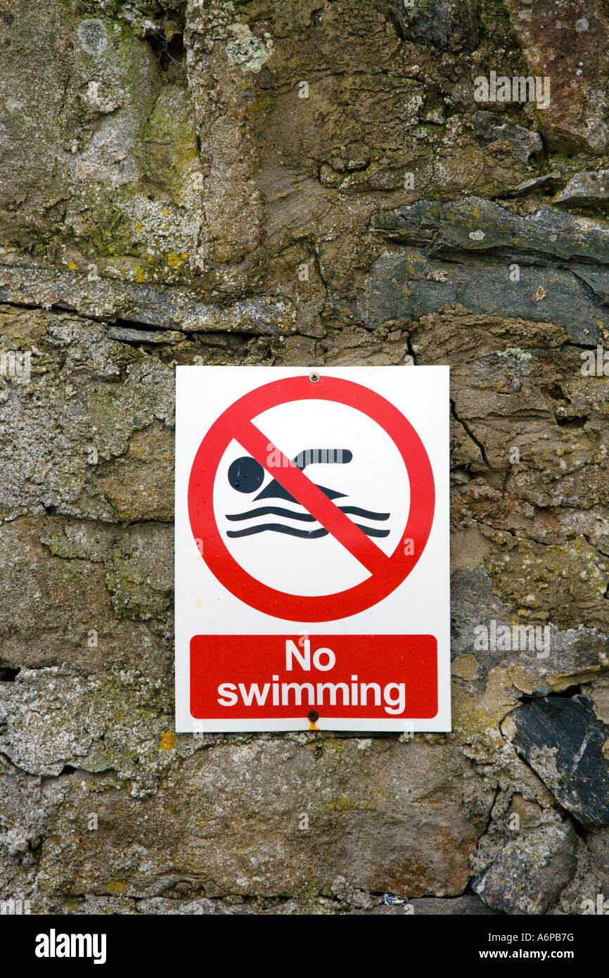 No Swimming sign on wall Stock Photo