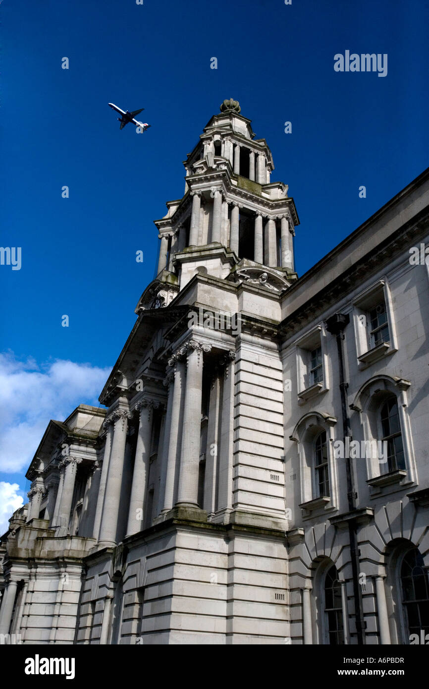 Aircraft flying over Stockport Town Hall (against blue sky) Stock Photo