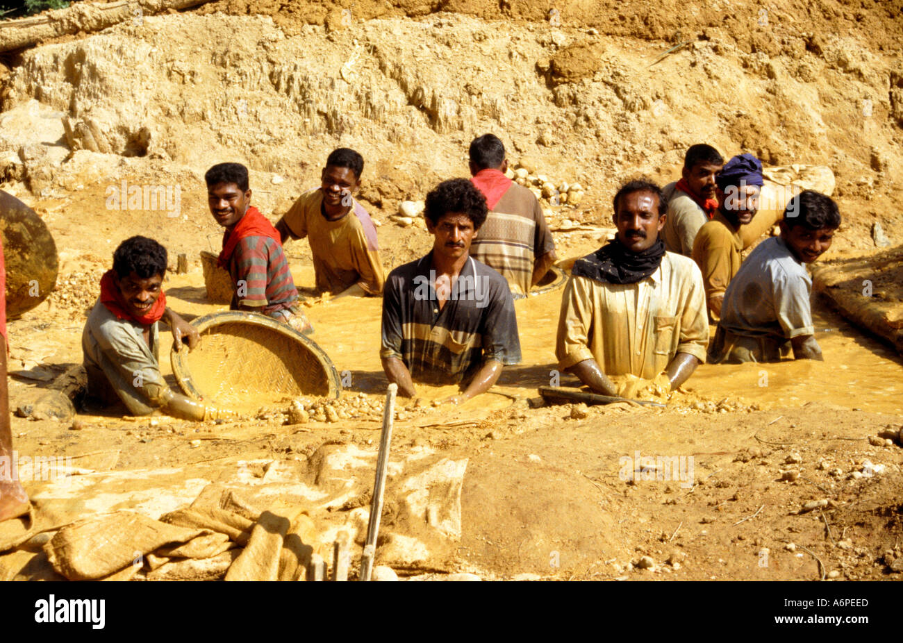 4 Mud is swirled around washing out the stones in gem mining near