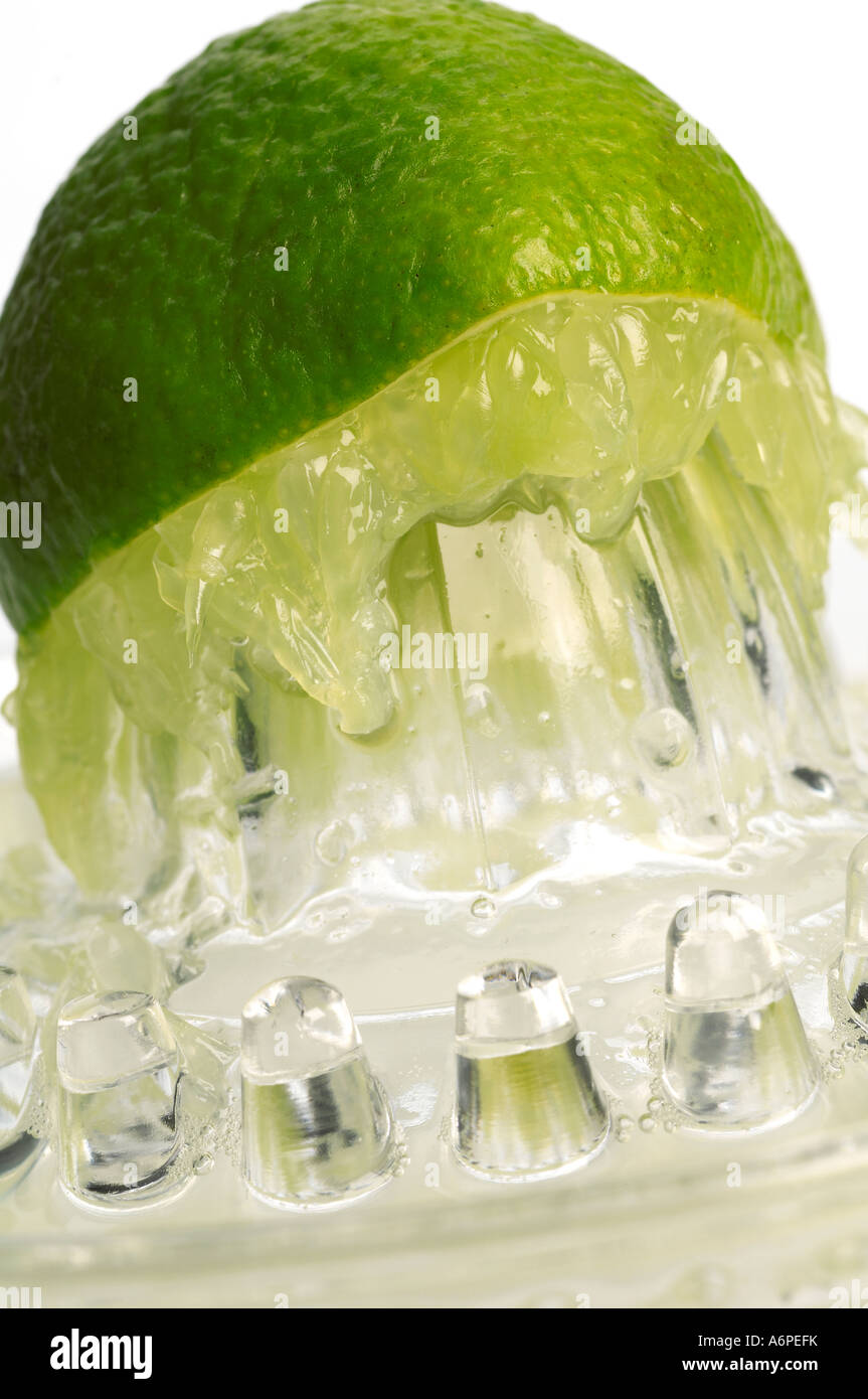 Lime being juiced on glass juicer Stock Photo Alamy