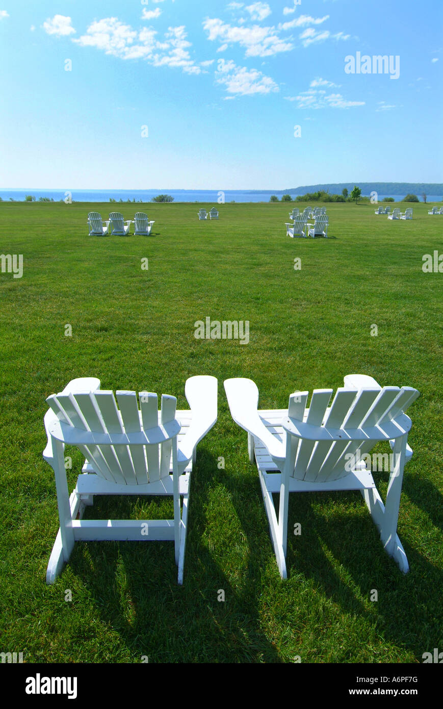 USA Michigan Mackinac Island Lake Huron white Adirondack chairs on lawn