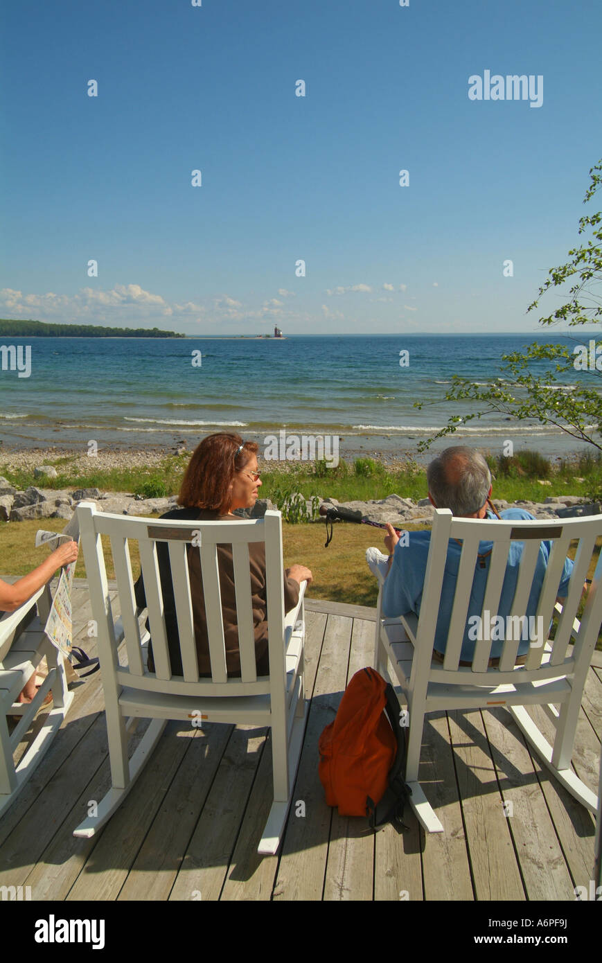 USA Michigan Mackinac Island Lake Huron Three adults sitting in wooden