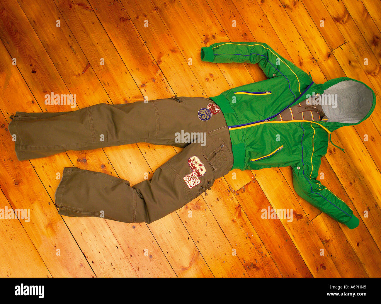 CLOTHES LAYING ON THE FLOOR IN THE SHAPE OF A PERSON, BUT NO ONE WEARING THEM. Stock Photo