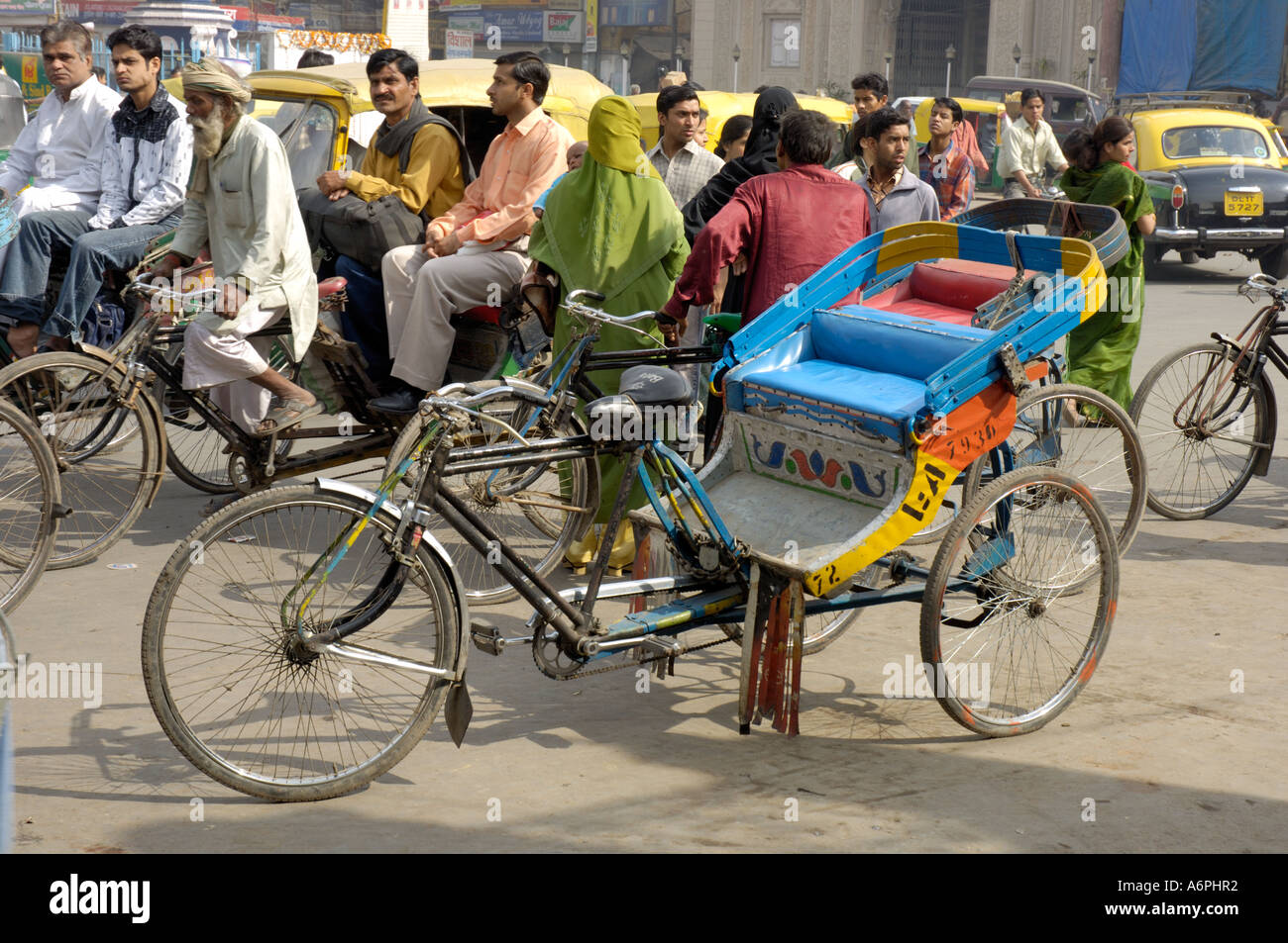 Cycle rickshaw amongst chaotic traffic Chandni Chowk Old Delhi