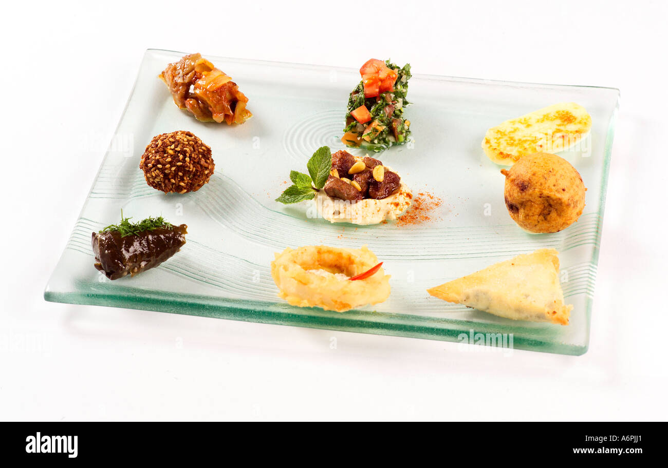 A SELECTION OF HOT AND COLD MEZE ON A GLASS PLATE Stock Photo