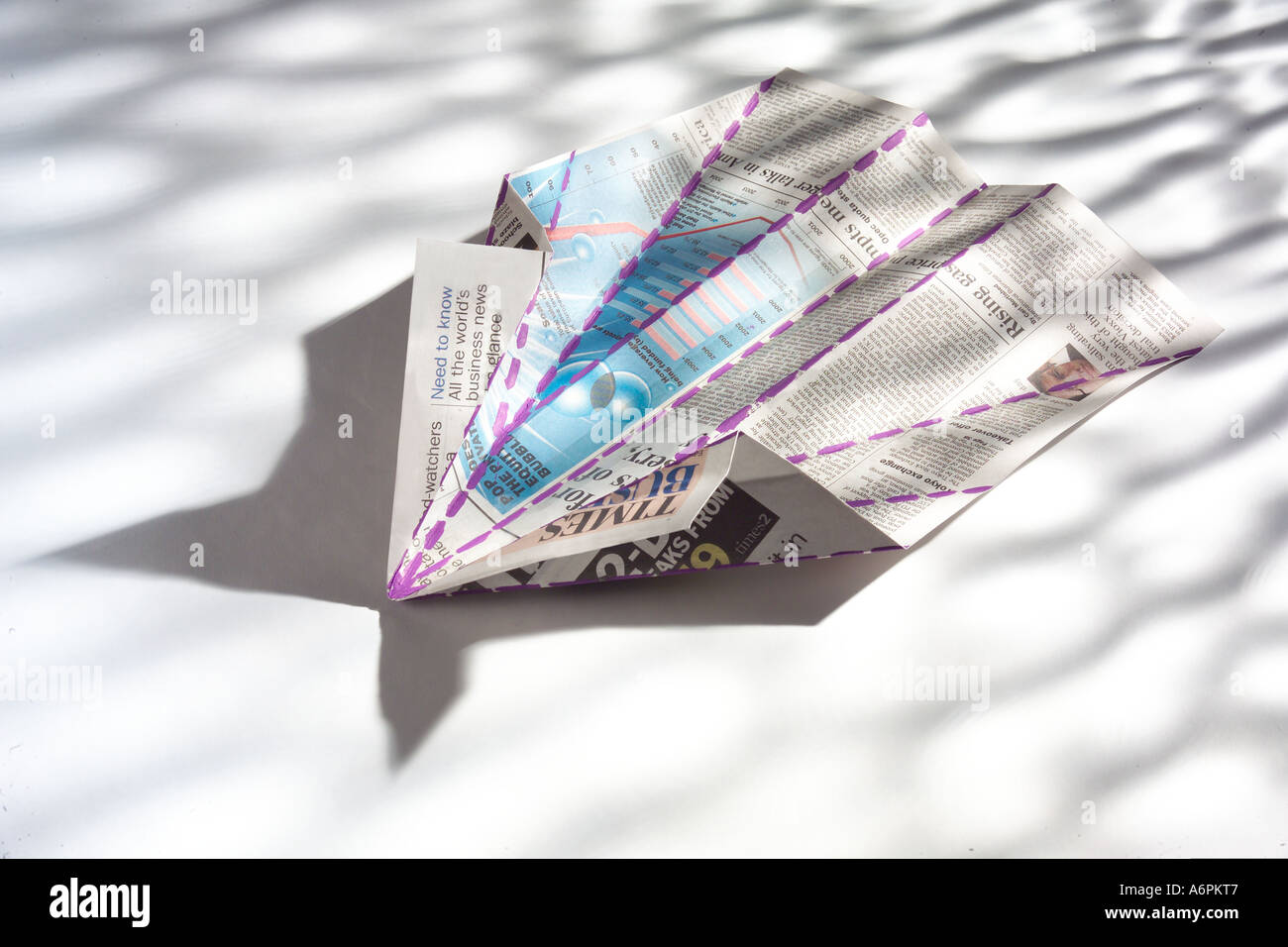 PAPER AIRPLANE DIAGRAM MODEL MADE FROM NEWSPAPER Stock Photo