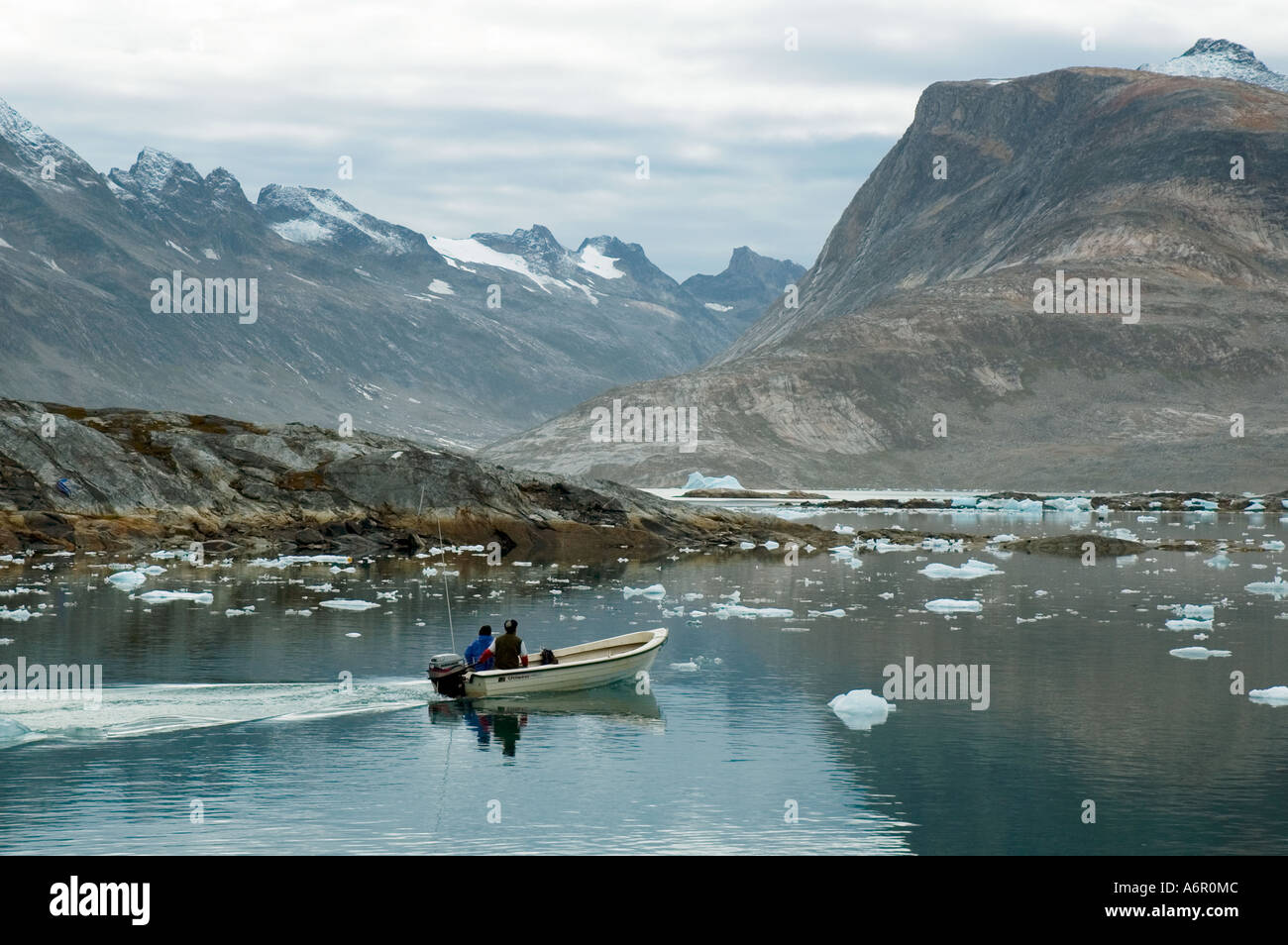 Inuit fisherman leaving the village of Tiniteqilâq, Sermilik Fjord, East Greenland Stock Photo