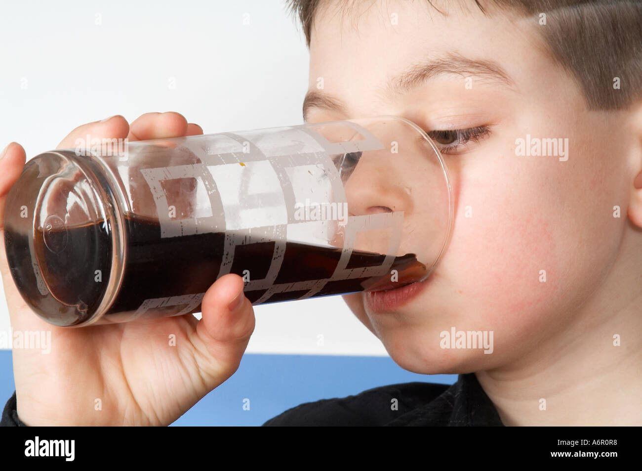 Young, boy, child, kid, drinking,  soft, drink, cola, orange, sip, tasty, taste, colourings, colorings, colour, color, artificia Stock Photo