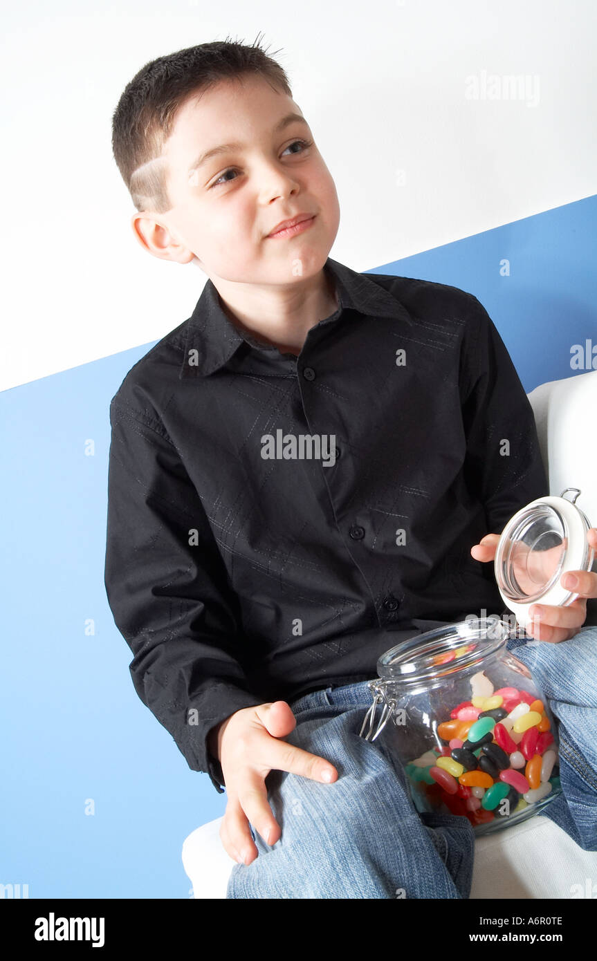 Young, boy, child, kid, eating, jelly beans, sweets, sweeties, candy, food, colourings, colorings, colour, color, artificial, fl Stock Photo